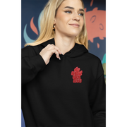 woman smillingwhile wearinga black hooded sweathirt with a patch on the left chest that reads"Do What You Love"