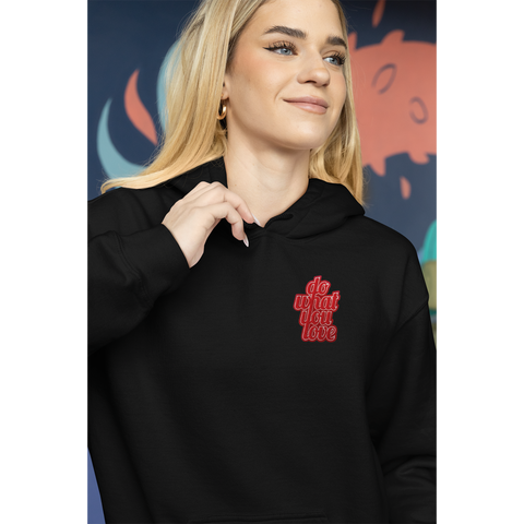 woman smillingwhile wearinga black hooded sweathirt with a patch on the left chest that reads"Do What You Love"